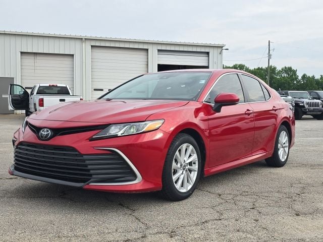 2024 Toyota Camry LE in Red — front three-quarter view
